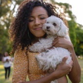 young-lady-cuddling-a-small-white-dog